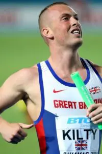 Richard Kilty crosses the line in the first round of men's 4x100m action