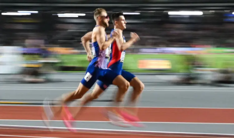 Two runners, Norway's Jakob Ingebrigtsen (R) and Britain's Josh Kerr race each other, against a blurred background